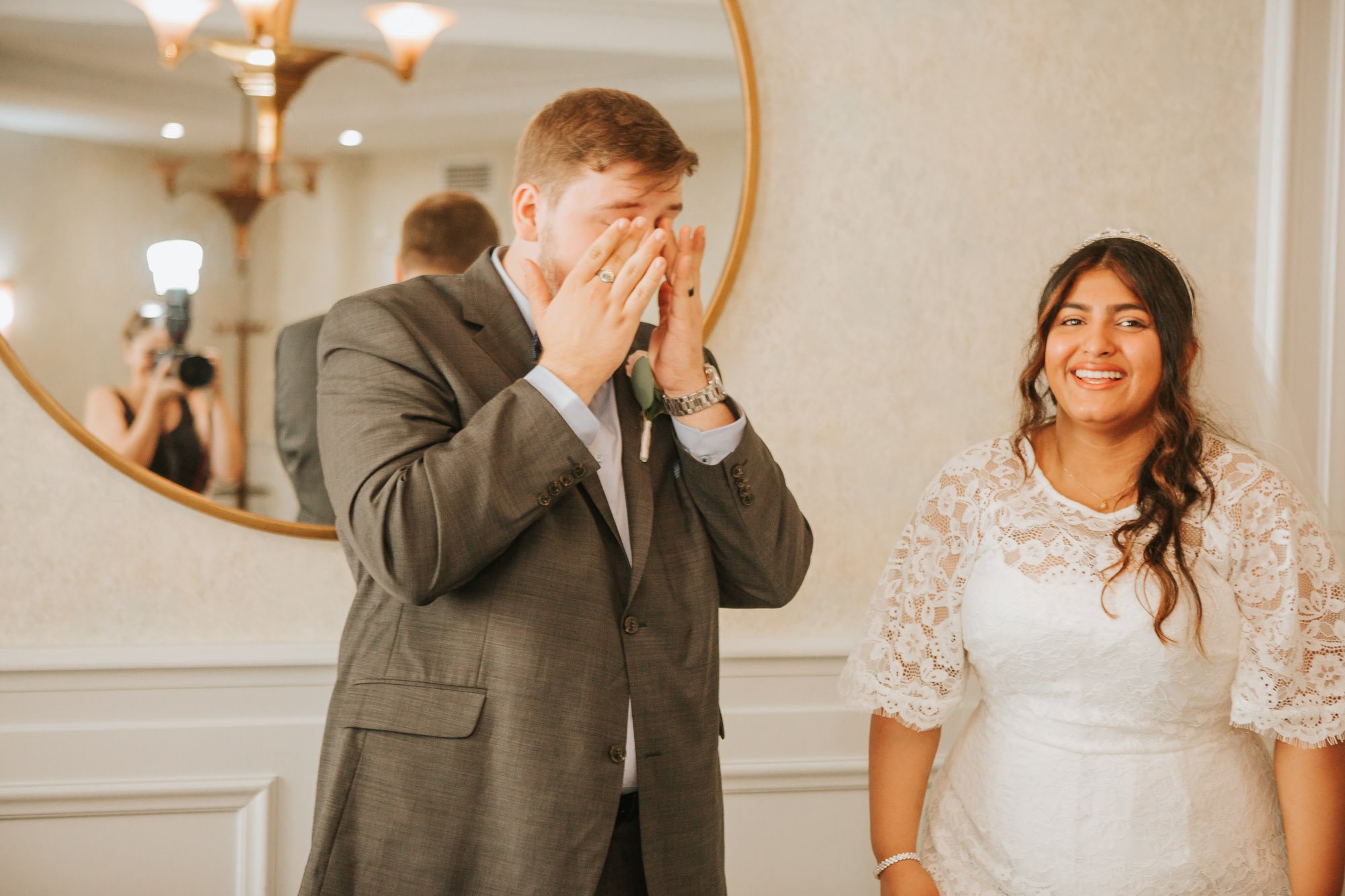  An emotional groom wells up after marrying his bride, while the wedding photographer can be seen capturing the moment! 