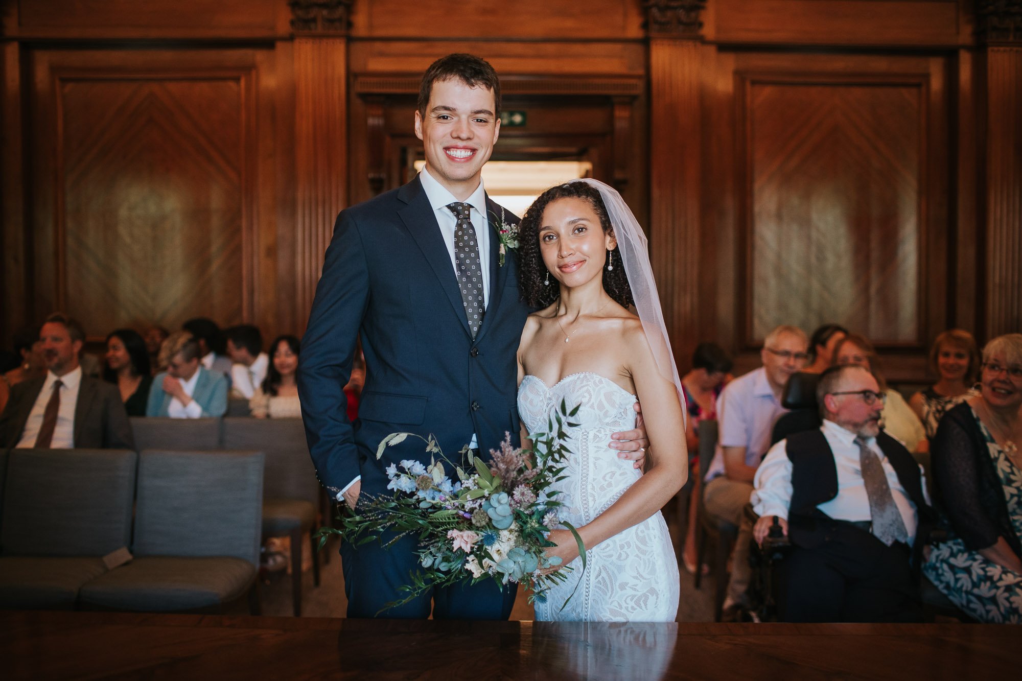  A bride and groom getting married in the Westminster room at Marylebone town hall in Marylebone, London. 