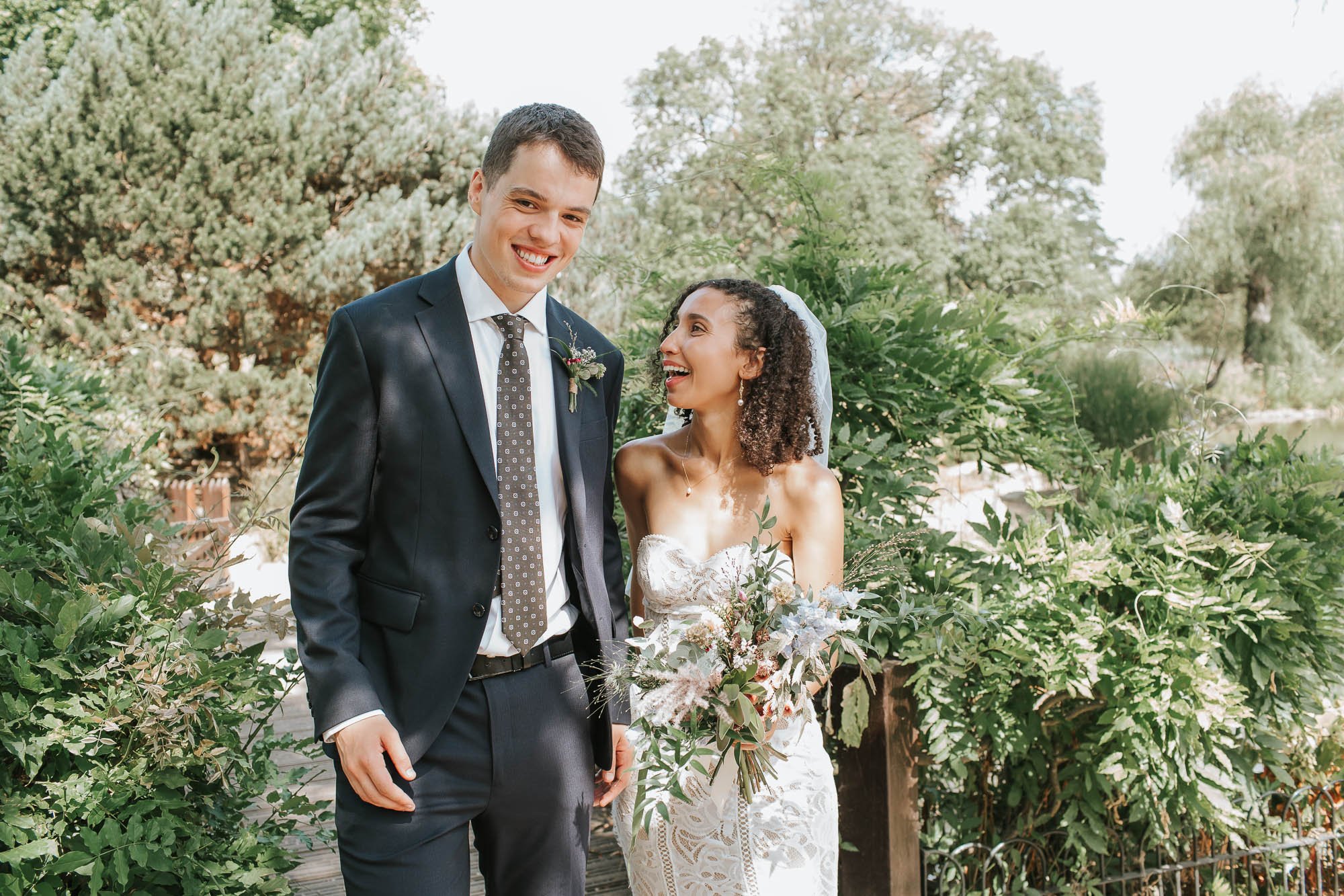  Bride and Groom looking at each other and laughing in Regents Park in London. 