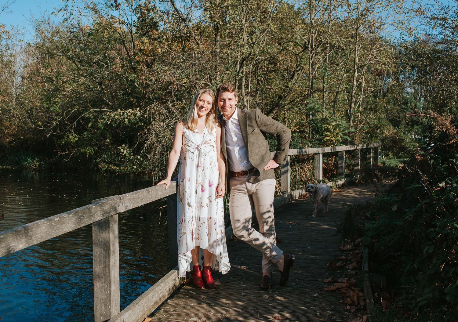  Newly engaged couple Michael and Caroline standing together by the lake on Wandsworth Common in South West London. 