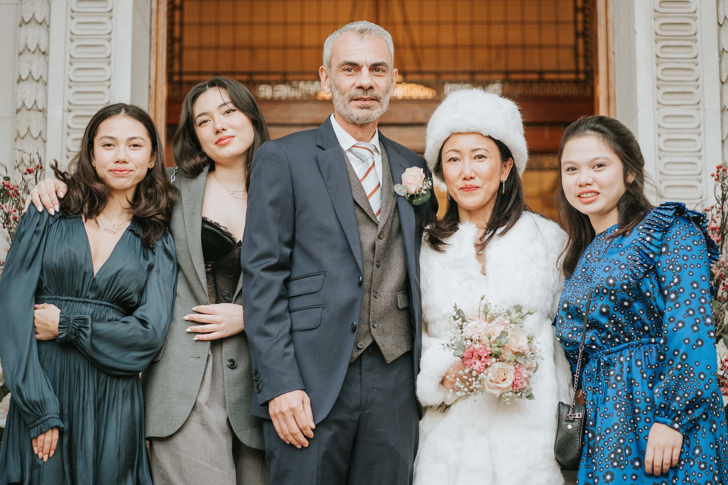  Bride, Groom and their three daughters pose outside Marylebone Old Town Hall. 