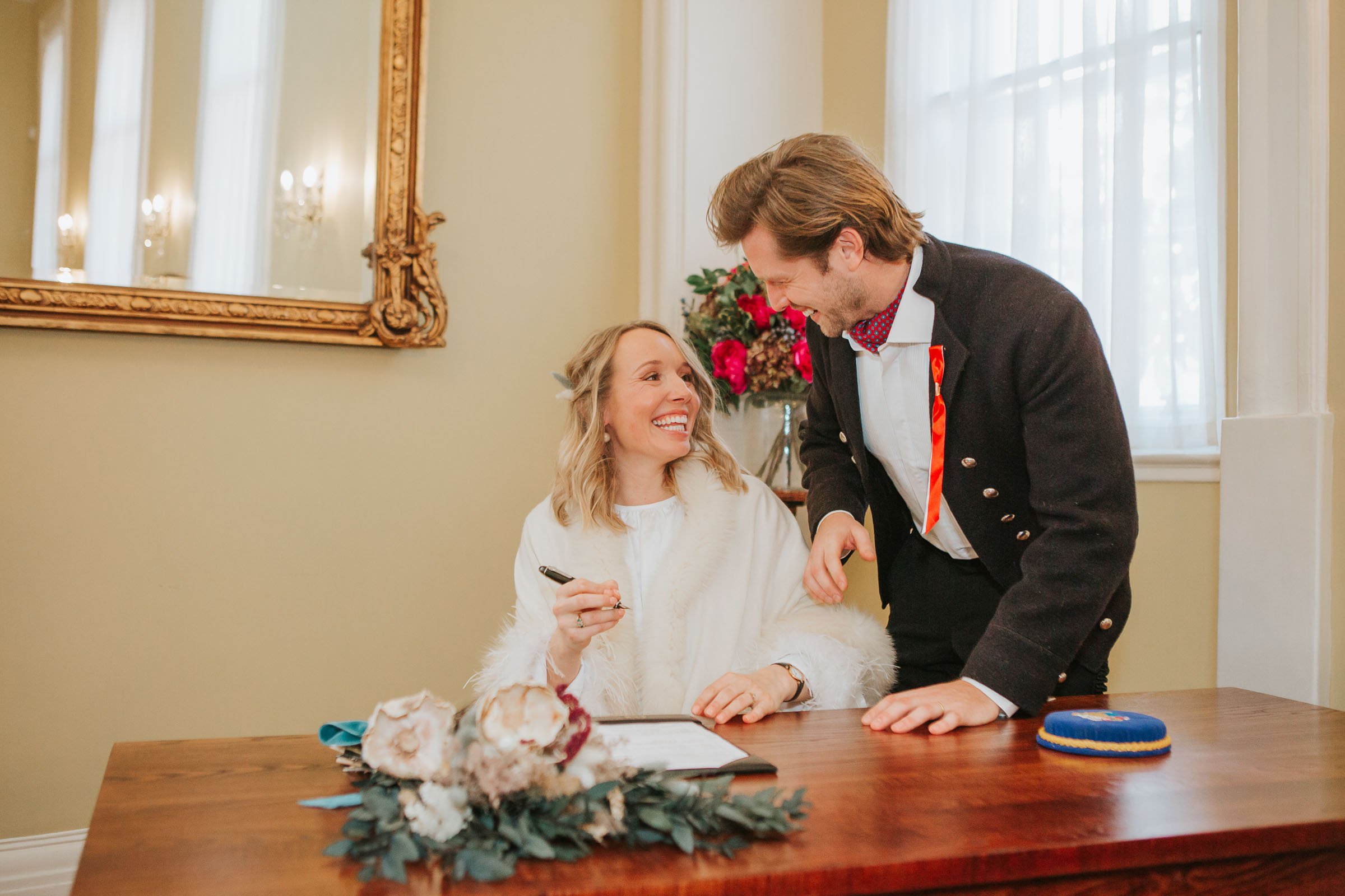  Lizzie and Max signing the register in front of their friends and family in The Byron Room at Chelsea Old Town Hall.  