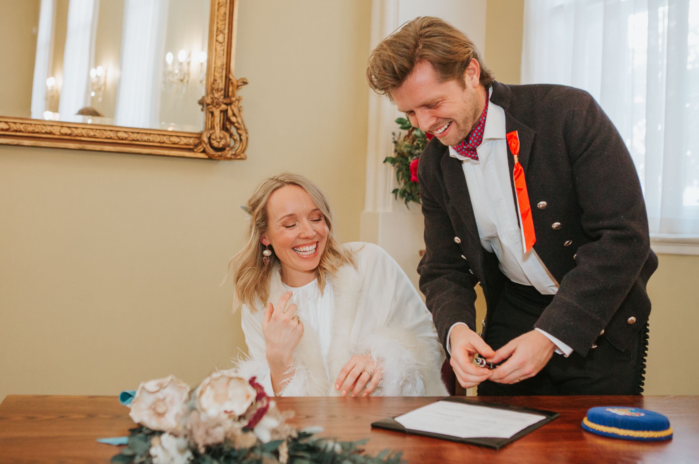  Lizzie and Max signing the register in front of their friends and family in The Byron Room at Chelsea Old Town Hall.  