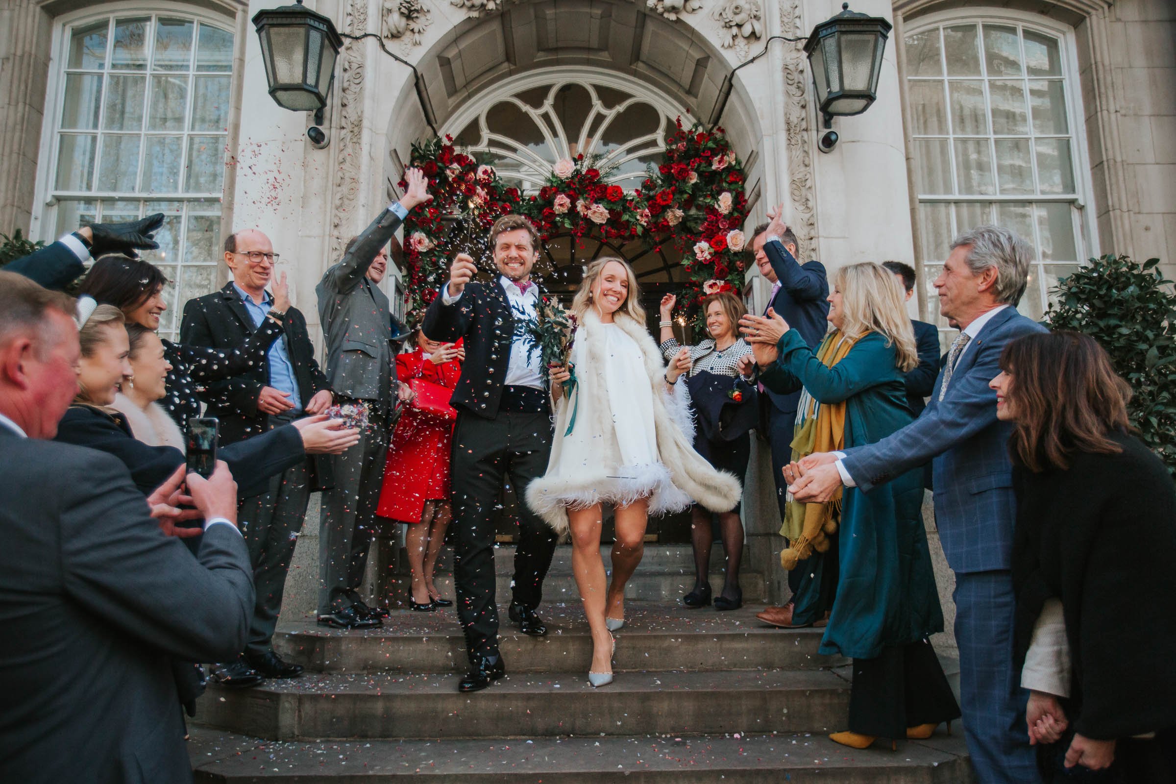  Friends and family of newly married Lizzie and Max shower them with confetti as they emerge on the steps outside Chelsea Old Town Hall. 