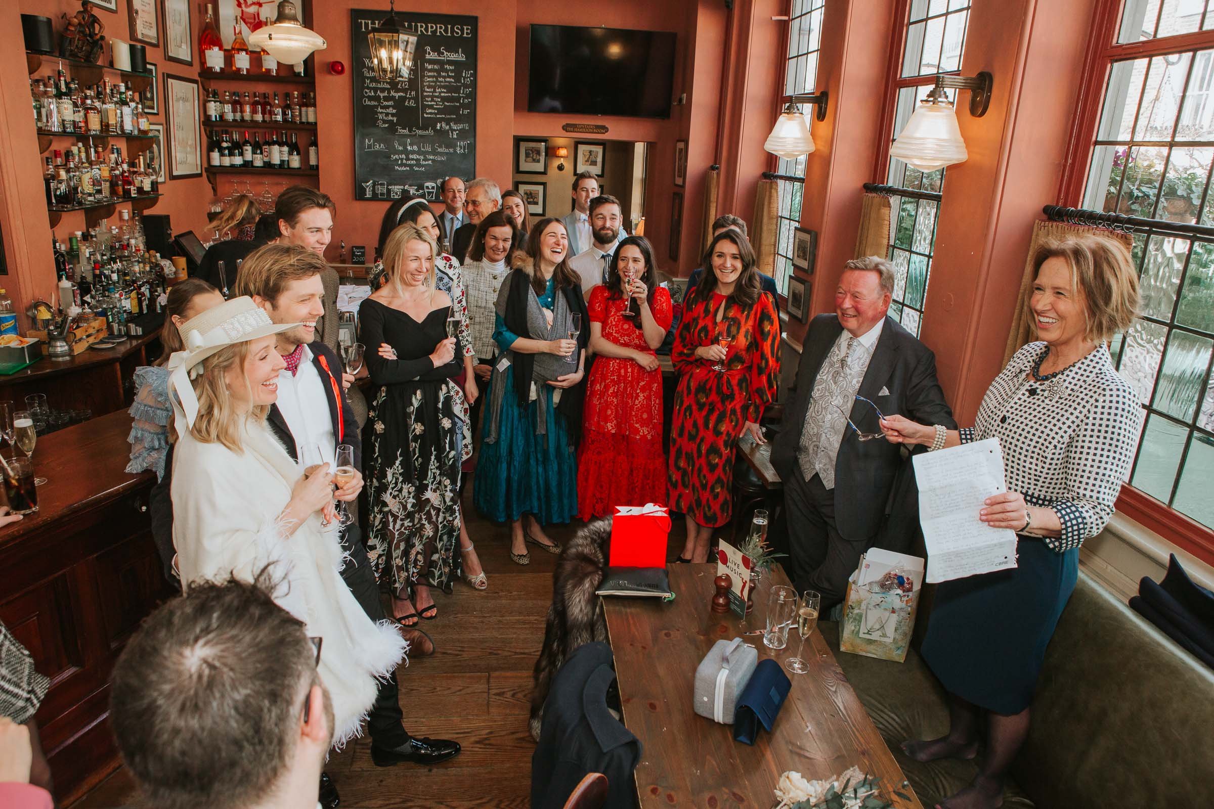  Max and Lizzie listen to wedding speeches taking place inside The Surprise Pub in Chelsea. 