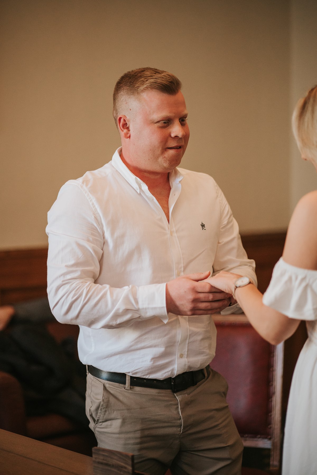  Steven and Sarah look at each other while exchanging vows at their wedding at The Elizabeth Room at Wandsworth Town Hall Registry Office. 