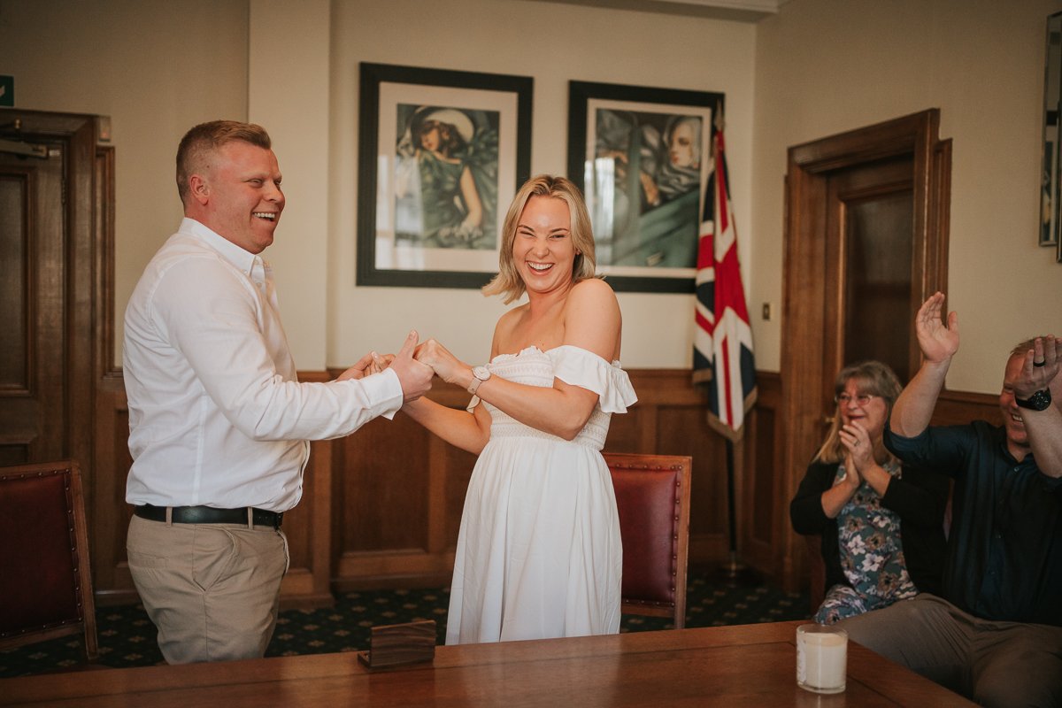  Bride and Groom just said I do at their wedding at Wandsworth Town Hall. Their family claps. 