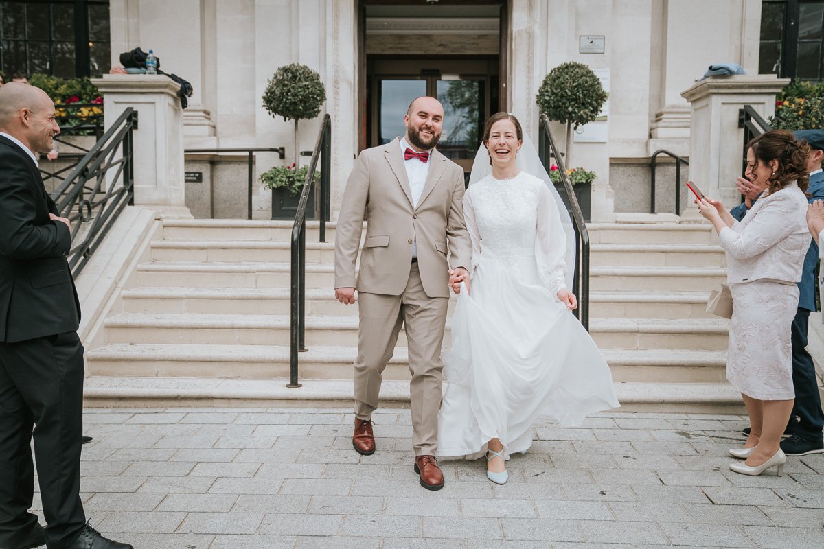  Edina and Zsolt, the bride and groom, on the steps outside Islington Town Hall after they got married. 