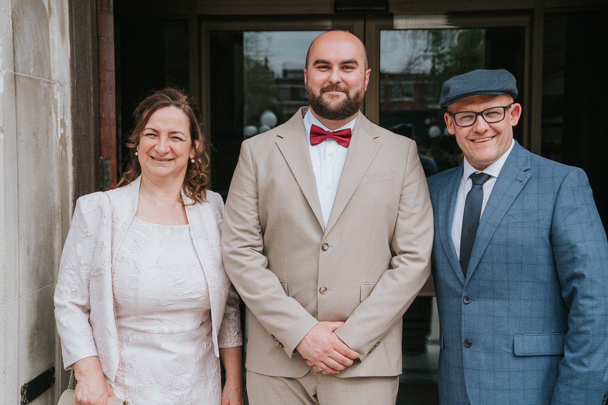  Zsolt, the groom, posing with his mum and dad outside Islington Town Hall after his wedding. 