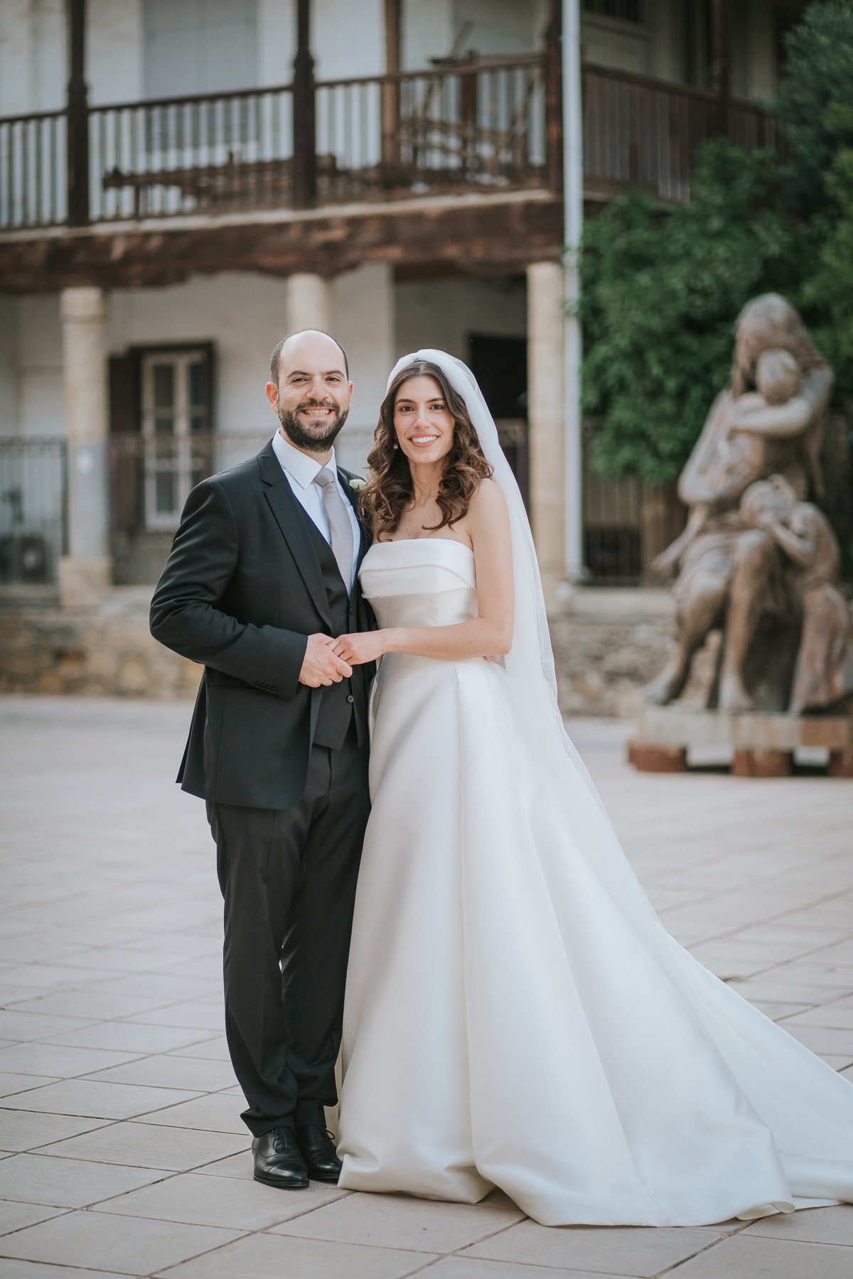  Bride and groom posing for a photograph by Christine Constantine Photography outside St John’s Cathedral in Nicosia, Cyprus. 