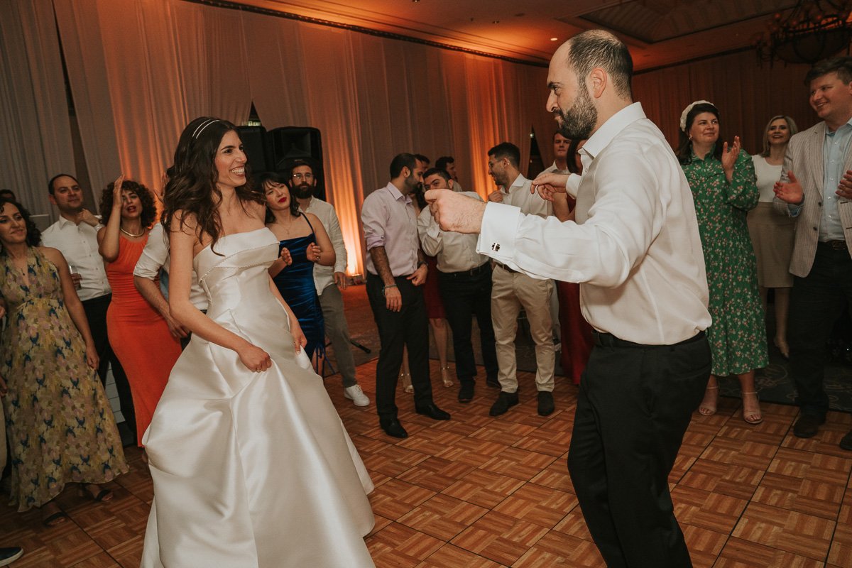  Bride and Groom and their friends and family dancing at Hilton Nicosia. 