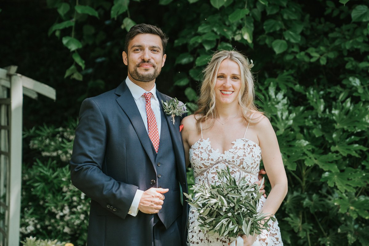  Bride and Groom posing for photographs in the garden of Southwark Register Office. 