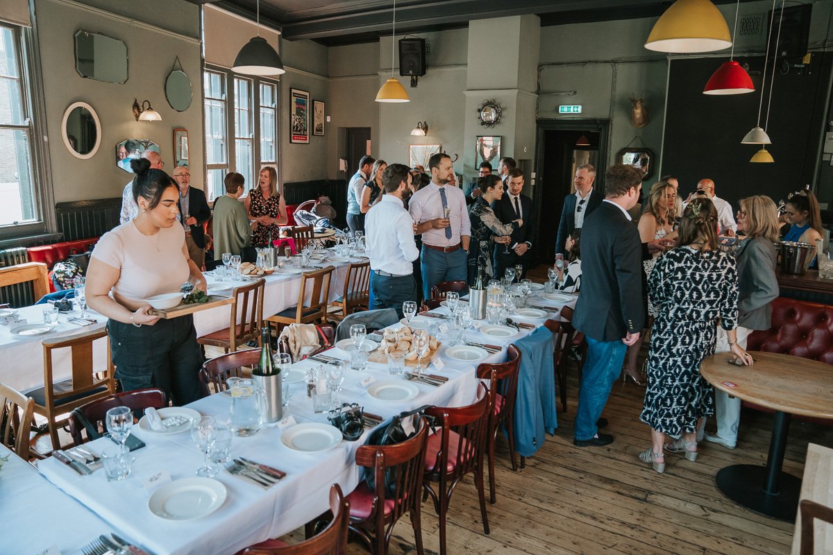  Wedding party in the upstairs dining room in The Roebuck Pub, Borough. 