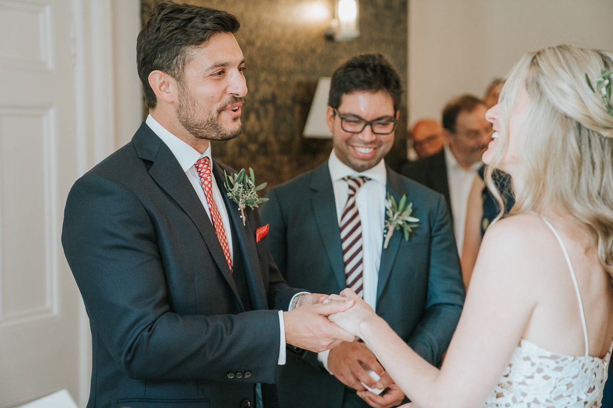  Bride and Groom face each other and exchange rings in Southwark Register Office. 