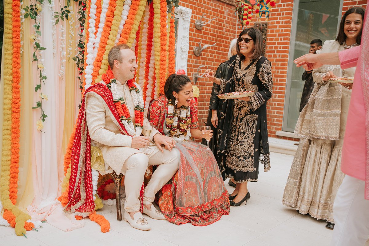  Bride and Groom eat sweet treats at their Mehndi Party. 