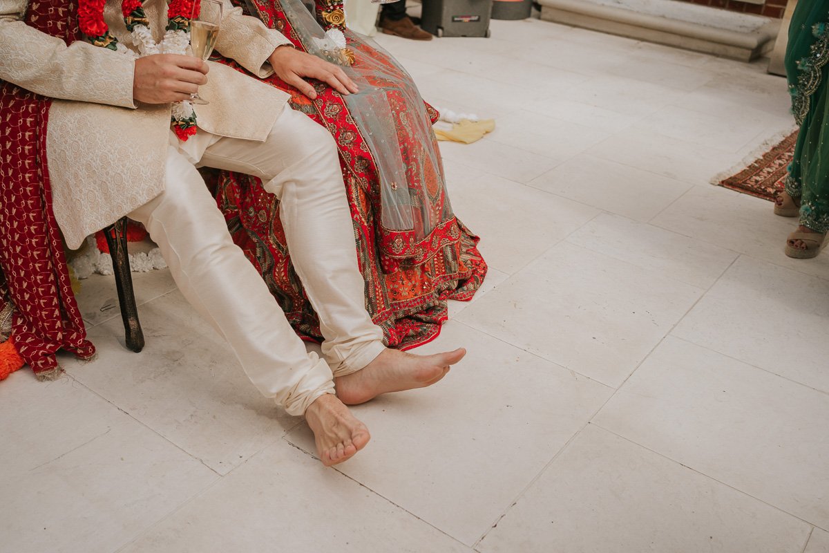 Groom sits without his shoes at Mehndi Party. 