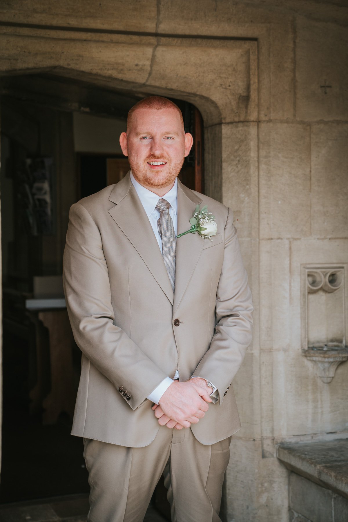  Groom stands outside St George’s Catholic Church. 