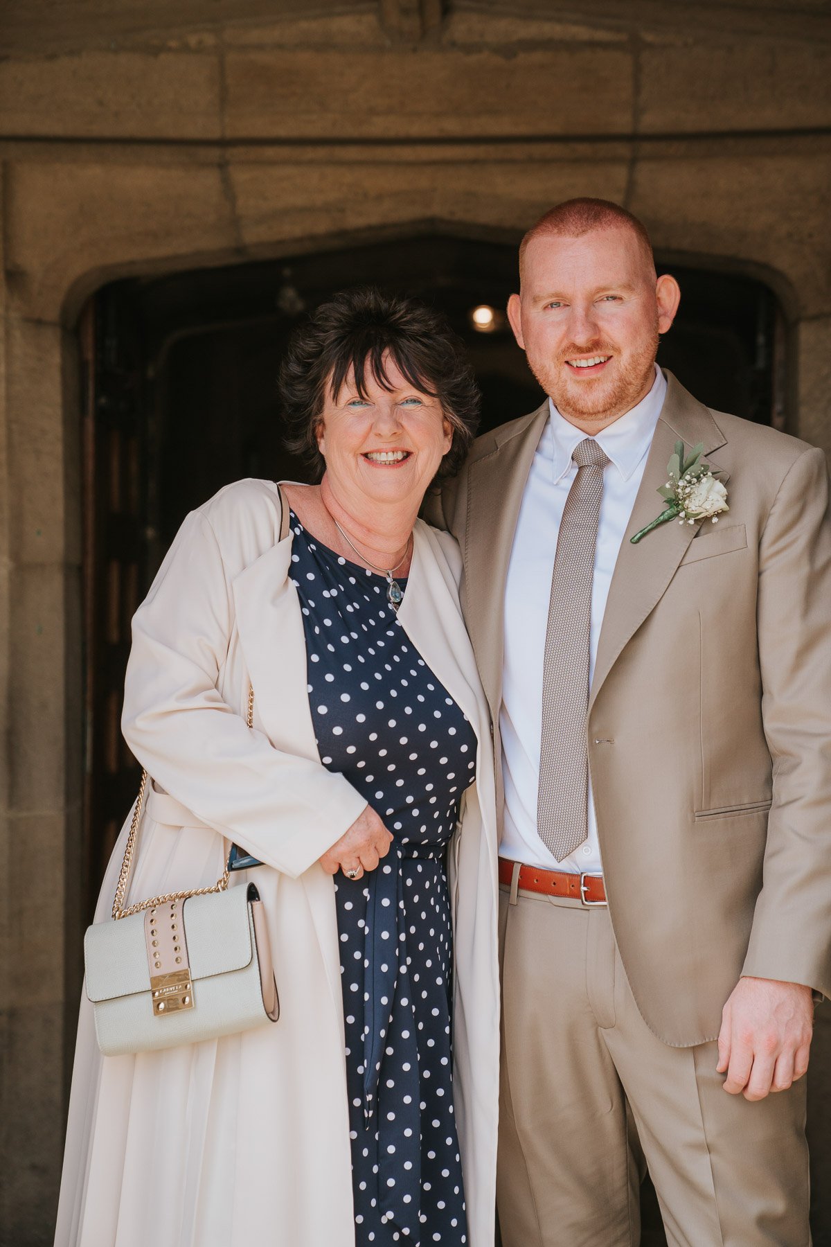  Groom and his mum stand outside St George’s Catholic Church. 