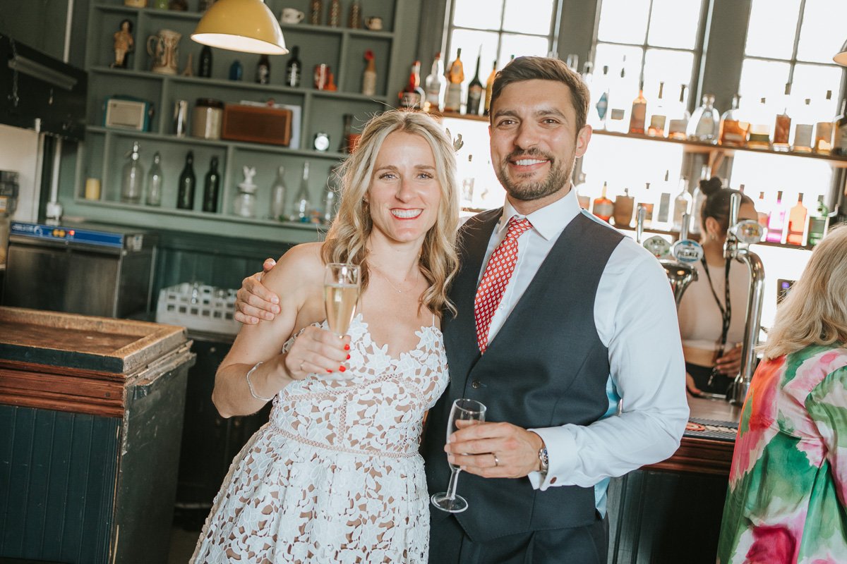  Bride and Groom standing in front of upstairs bar of The Roebuck public house on Dover Street in Borough. 