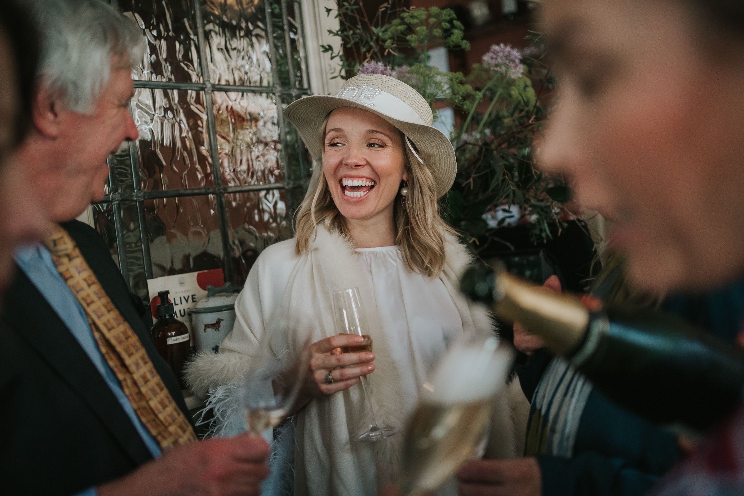  Bride laughs with her dad at the Surprise Pub in Chelsea. 