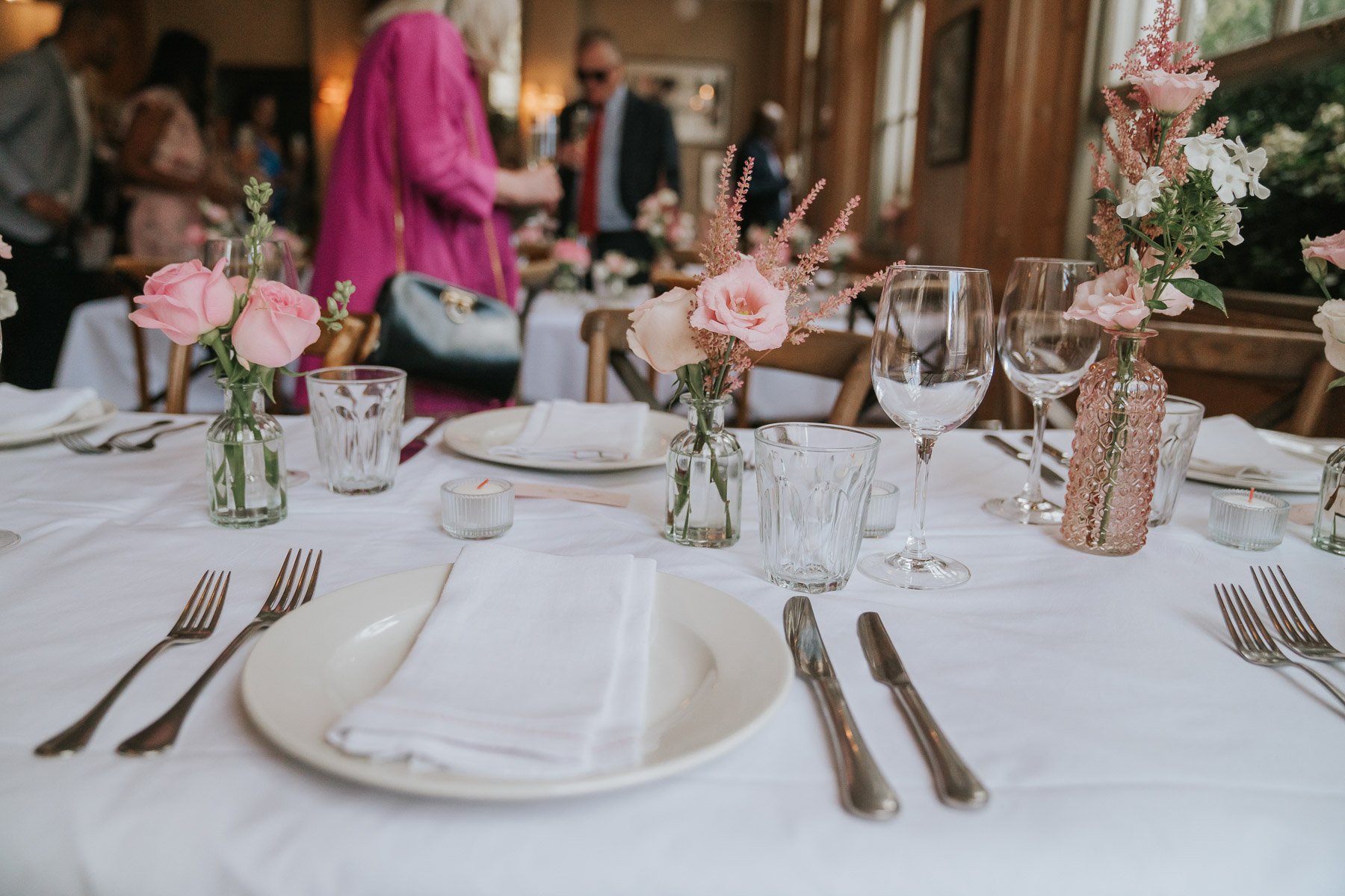  Plates, cutlery and glasses laid out on table in the Main Dining Room of  The Orange  in Belgravia. 