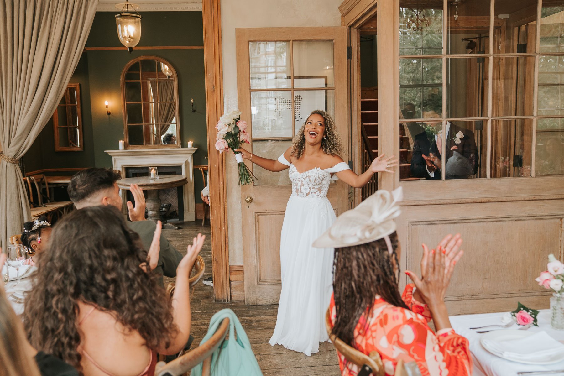  Bride and Groom walk into main dining room and guests clap. 