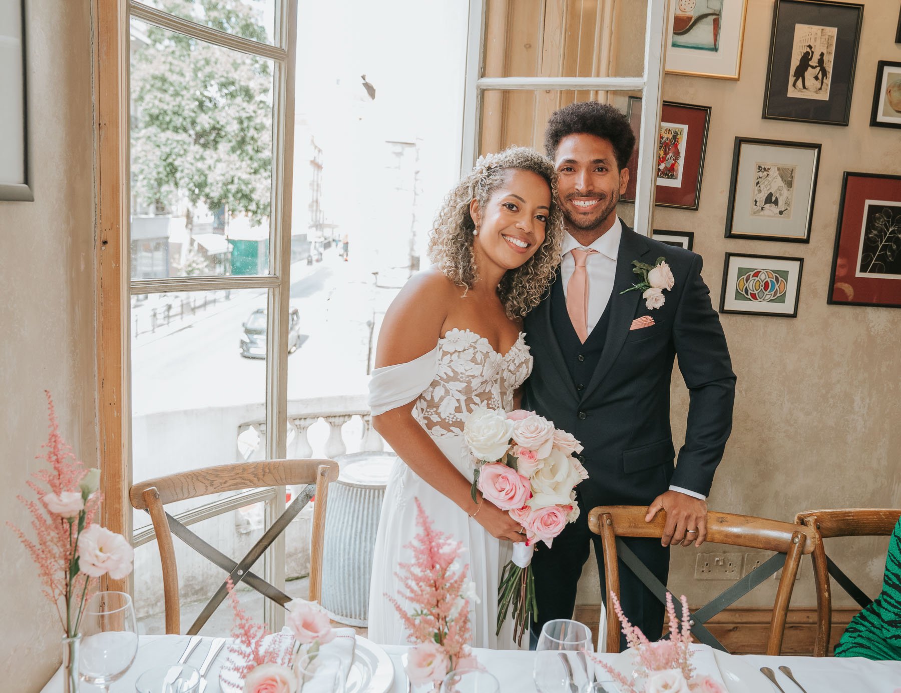  Bride and Groom pose at french window of main dining room at The Orange pub in Belgravia.. 