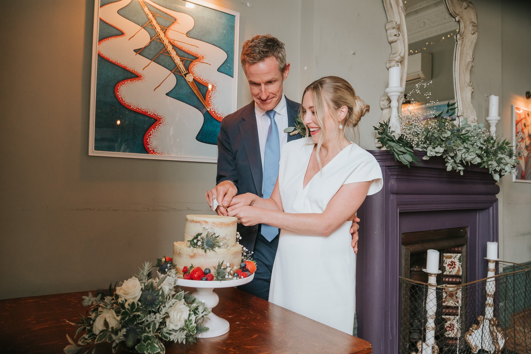  Bride and Groom cut their wedding cake in The Melrose Room at The Bulls Head. 