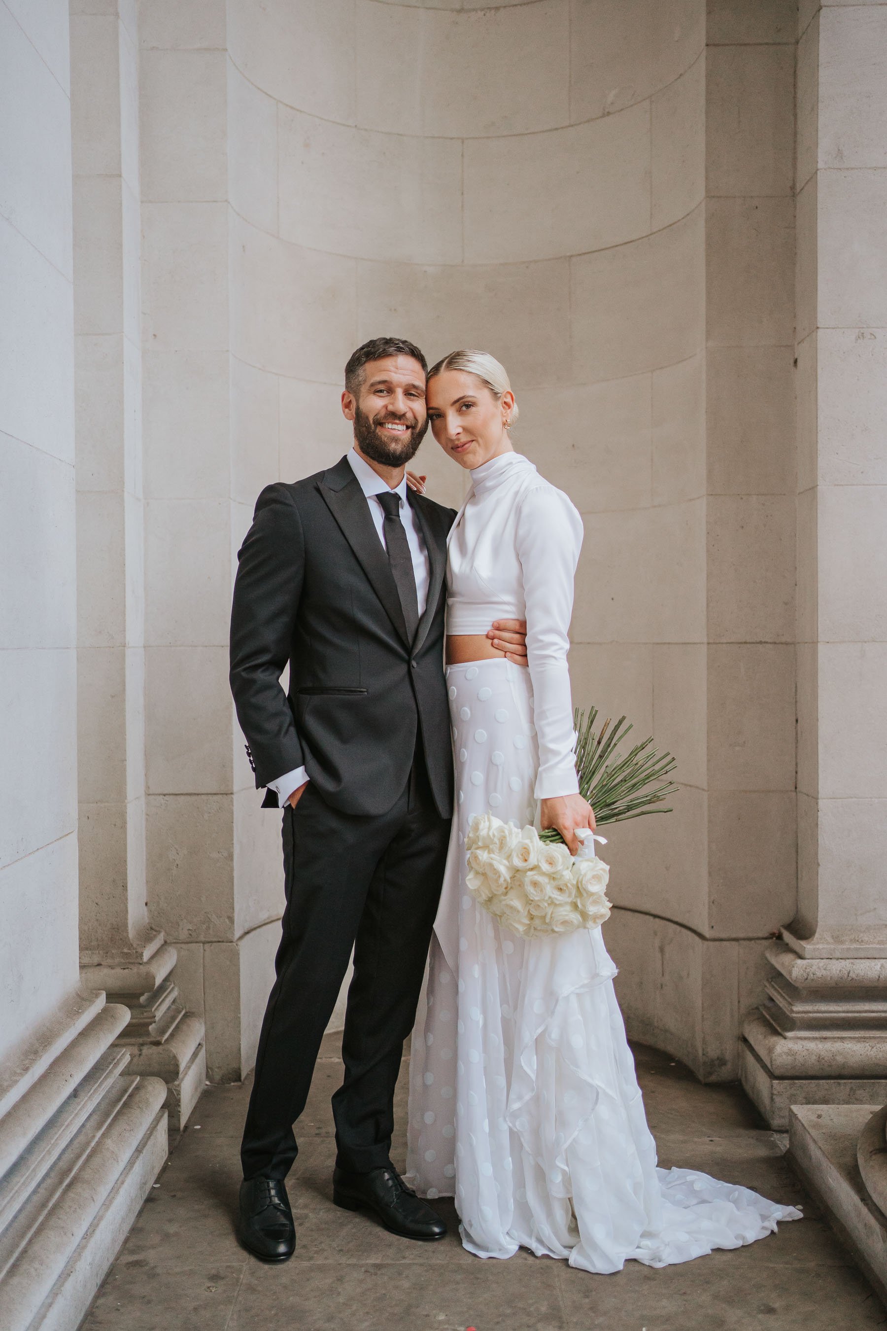  Bride and Groom pose outside Marylebone Old Town Hall. 