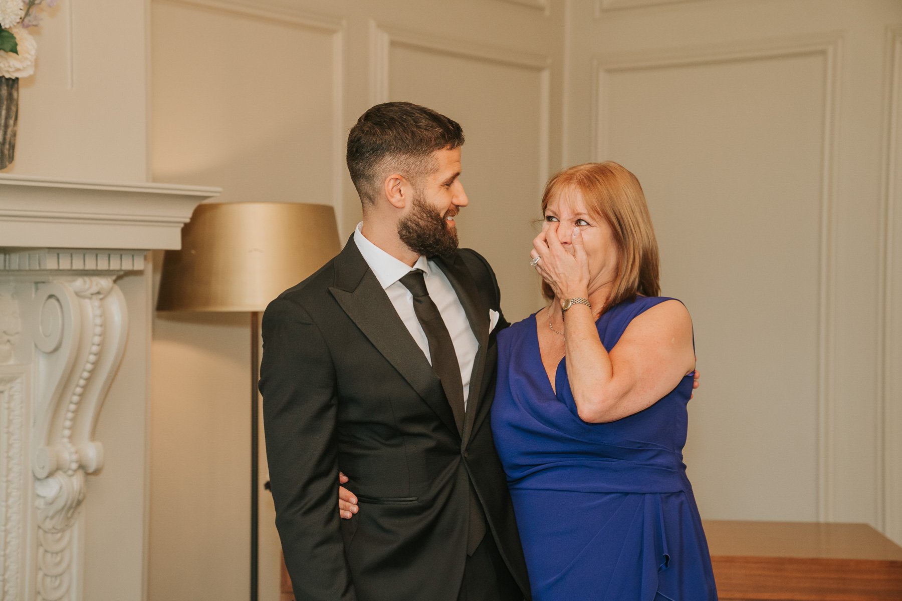  Groom with emotional mum in Pimlico Room of Marylebone Old Town Hall. 