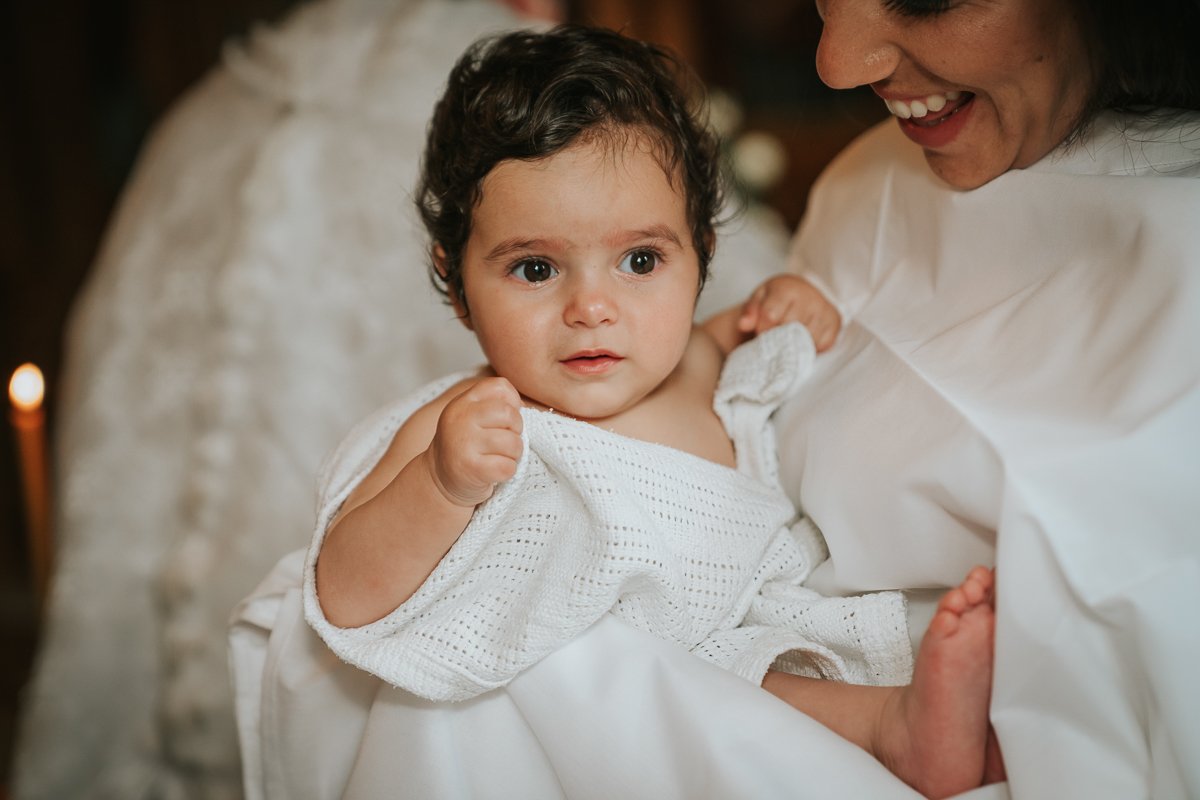  Godmother holds the baby girl after her christening. 