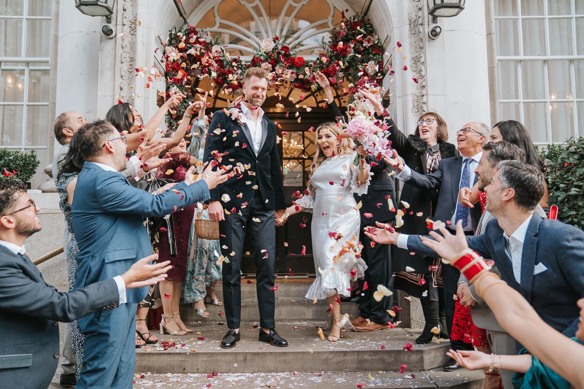  A newly-married couple stand on the steps of Chelsea Old Town while their friends shower them with confetti. 