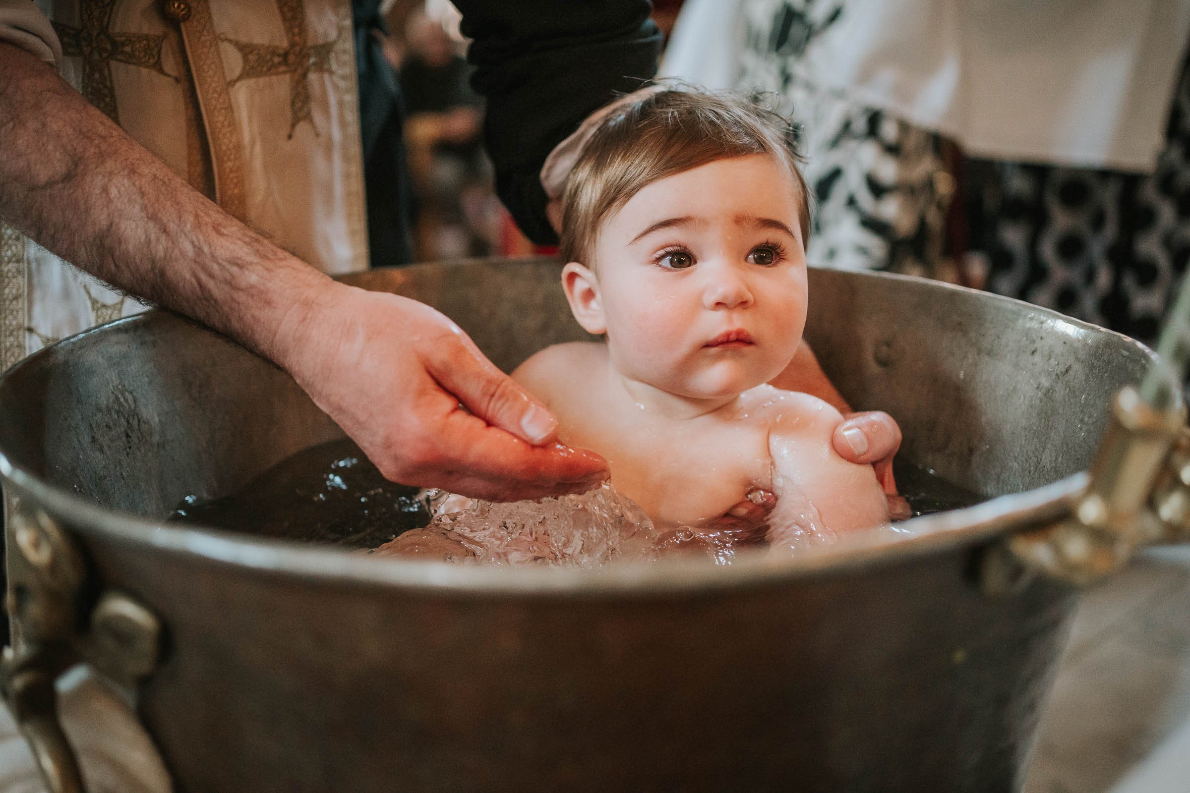  A baby boy in the font being Christened in the Greek Orthodox Church. 