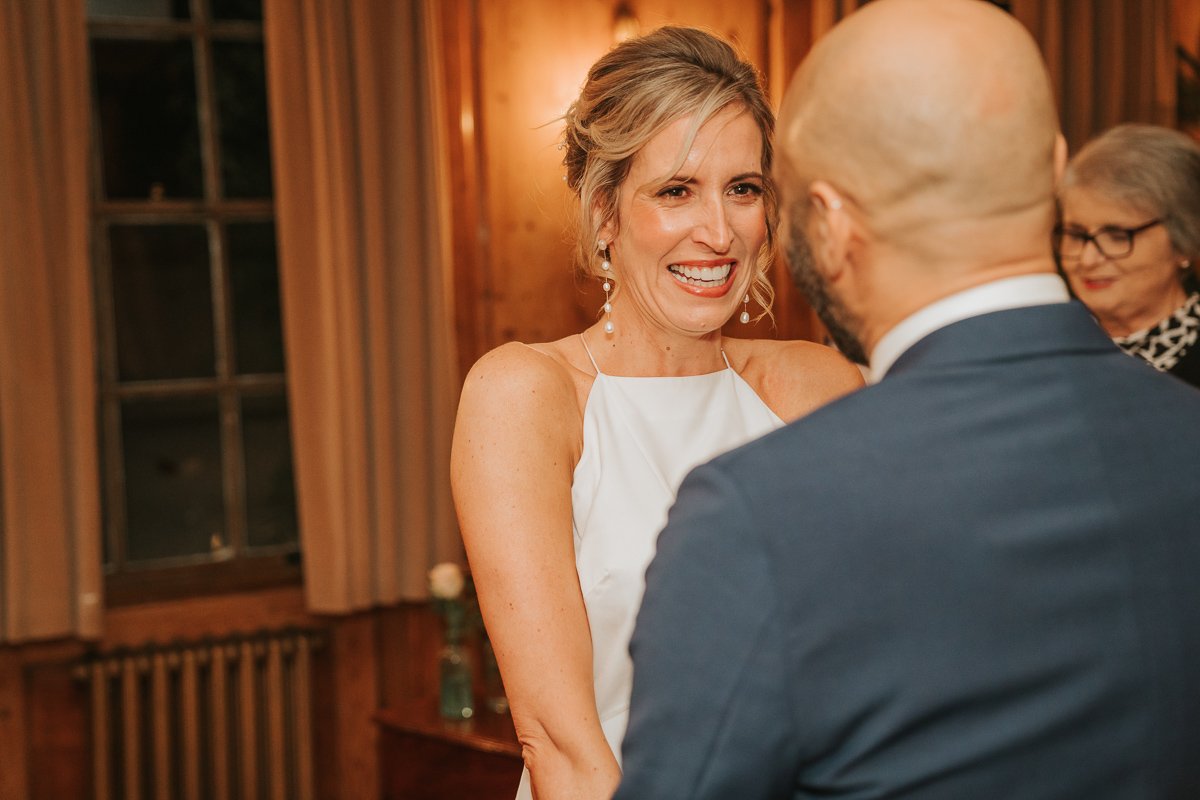  A smiling bride looks at her groom during their wedding at Burgh House. 