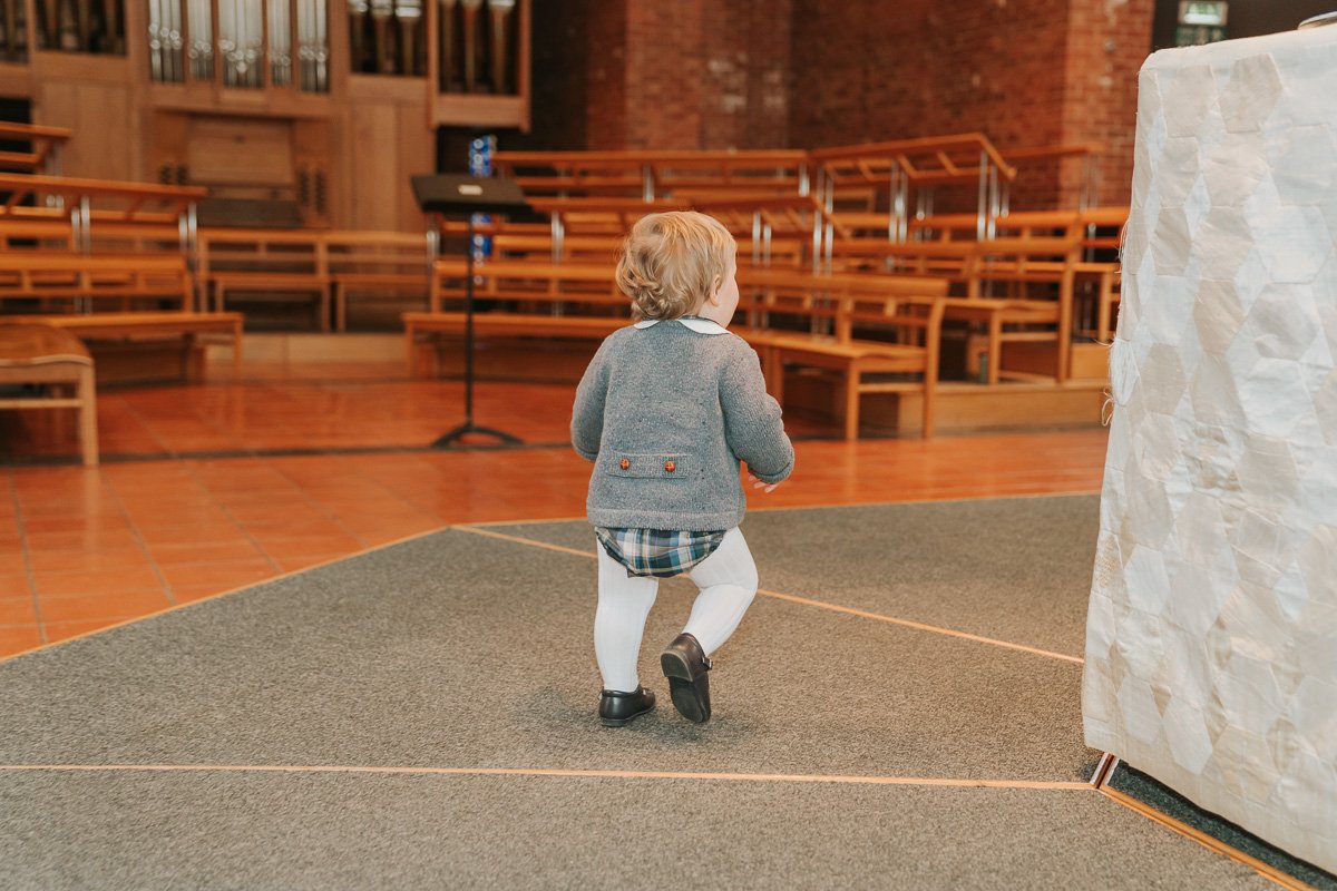  Baby Jude walks round the font in st barnabas church dulwich. 