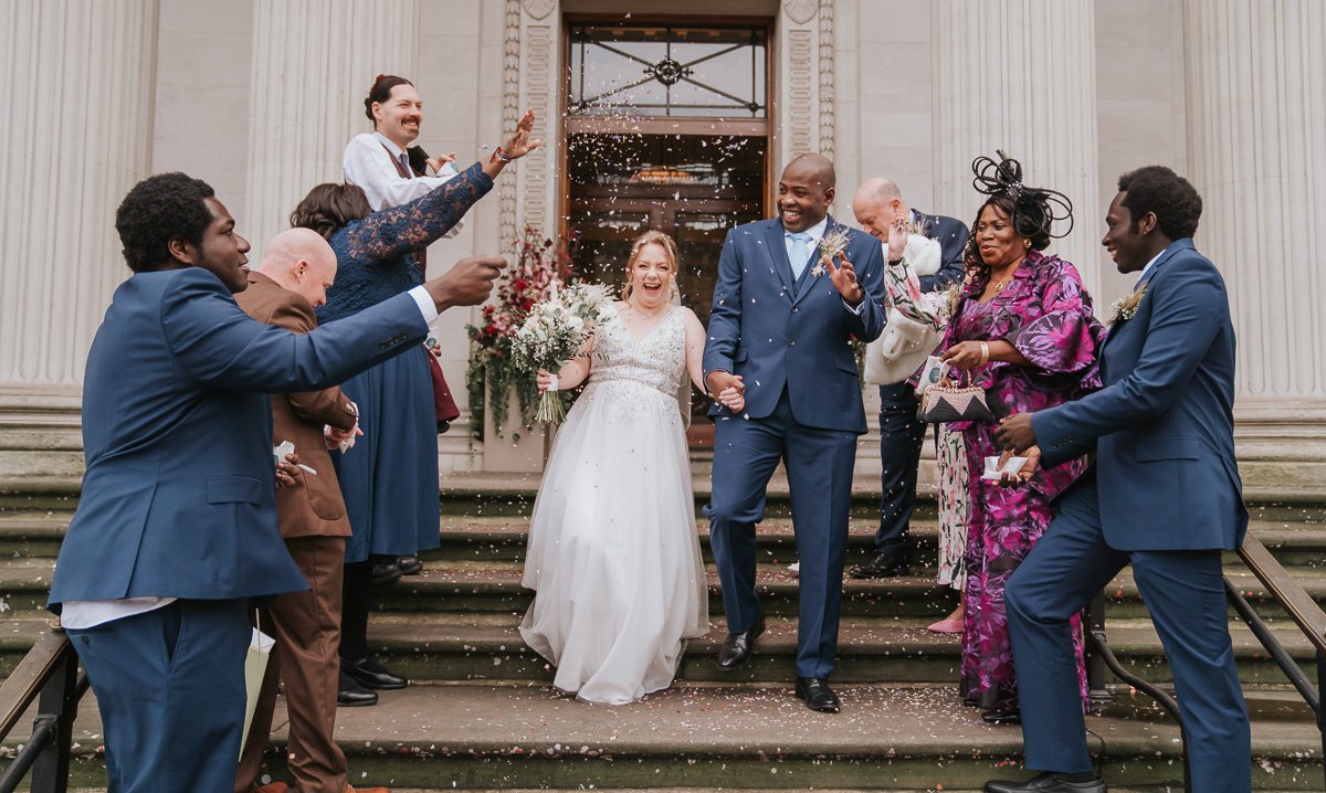  Confetti shot of the newly married bride and groom on the steps outside marylebone town hall. 