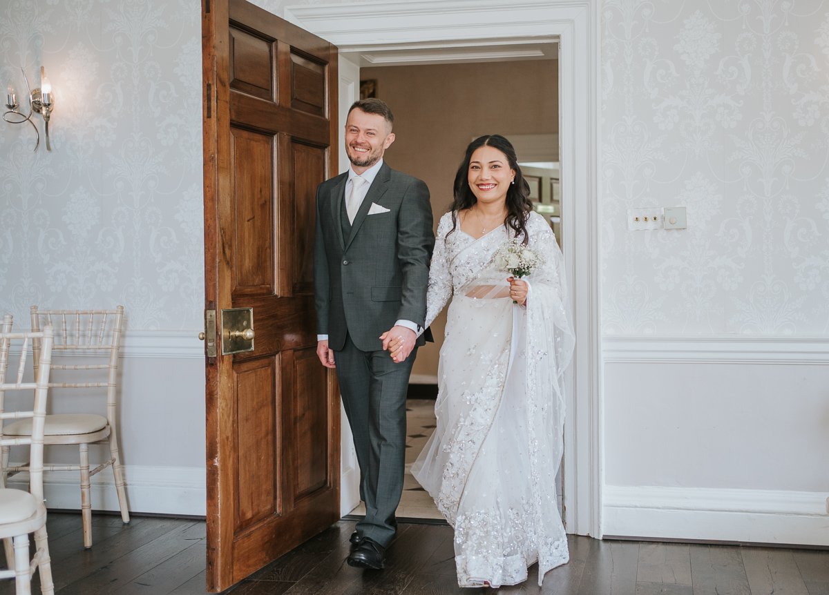  Bride and groom enter Sheridan Room at Morden Park House. 