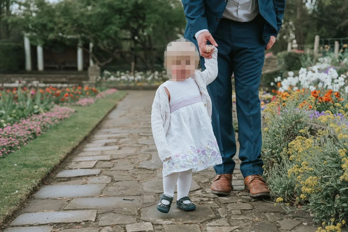 A father walks his small daughter through the gardens at Cannizaro House in Wimbledon. 
