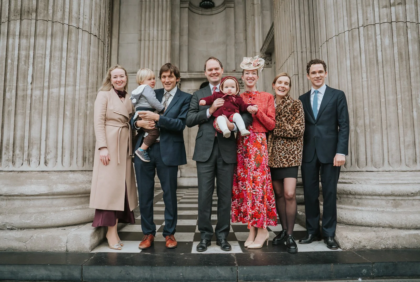  Extended family group photo on the steps of St Paul’s Cathedral following a London christening, natural light and iconic architecture 