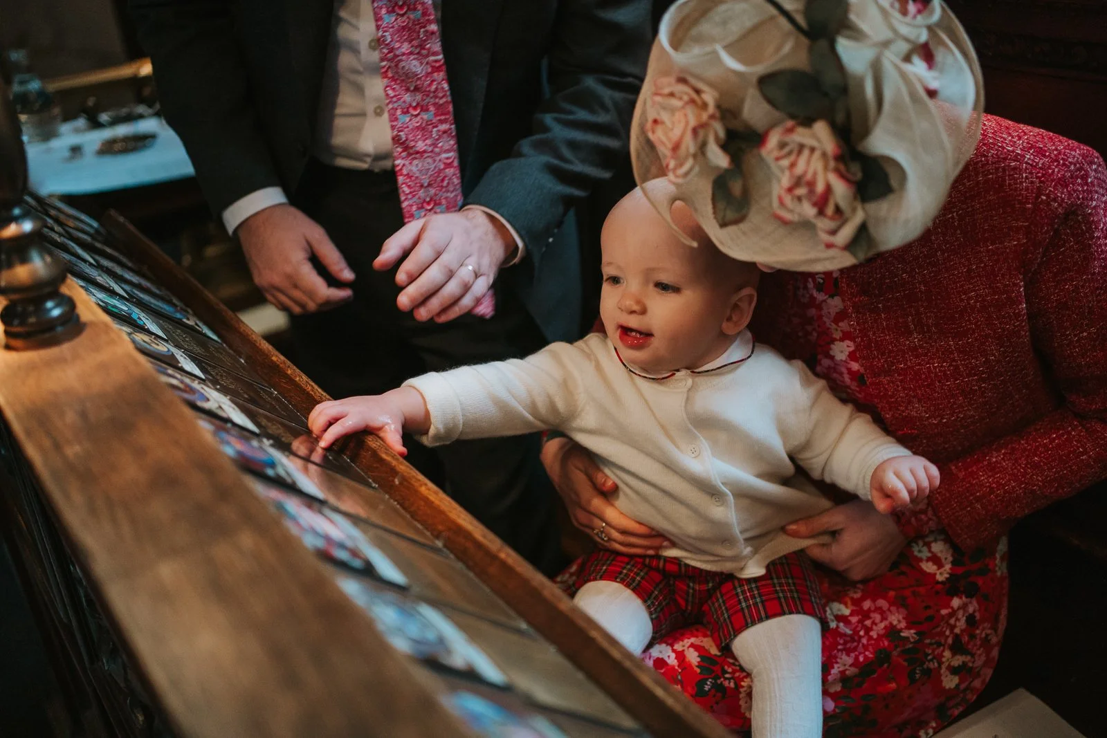  Candid moment of a baby reaching towards memorial plaques inside the Chapel of the Order of St Michael and St George, St Paul’s Cathedral 