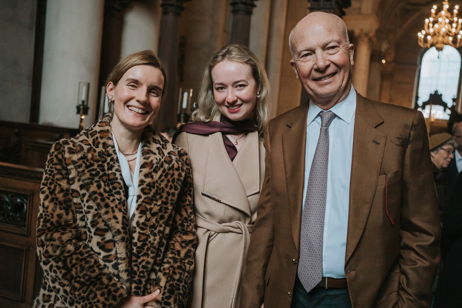  Guests smiling together inside the Chapel of the Order of St Michael and St George at St Paul’s Cathedral during a christening service 