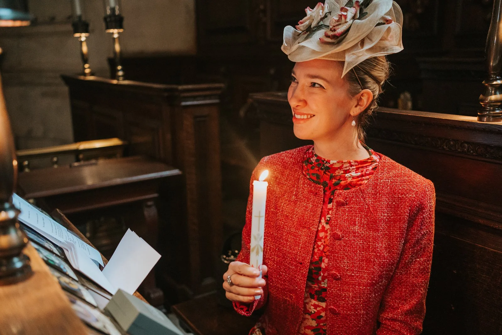  Mother holding a christening candle inside the Chapel of the Order of St Michael and St George, St Paul’s Cathedral, captured in low ambient light 