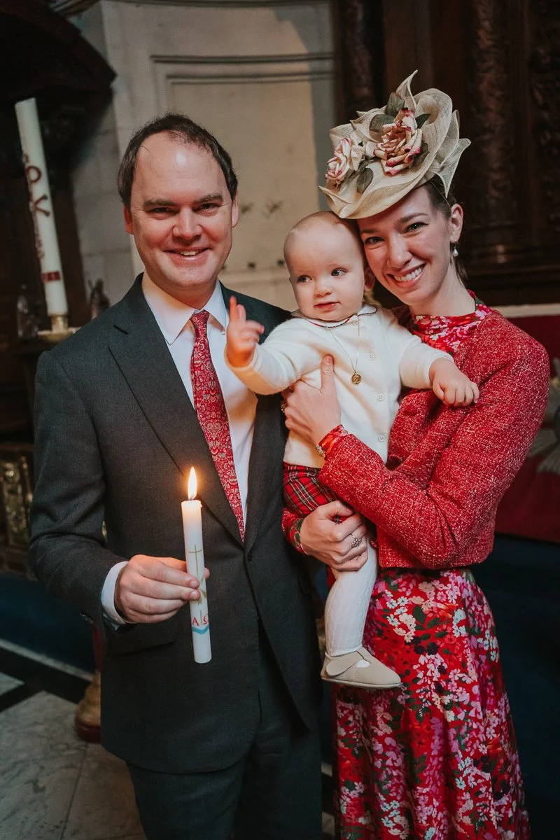  Parents and baby holding a christening candle inside the Chapel of the Order of St Michael and St George at St Paul’s Cathedral, London 