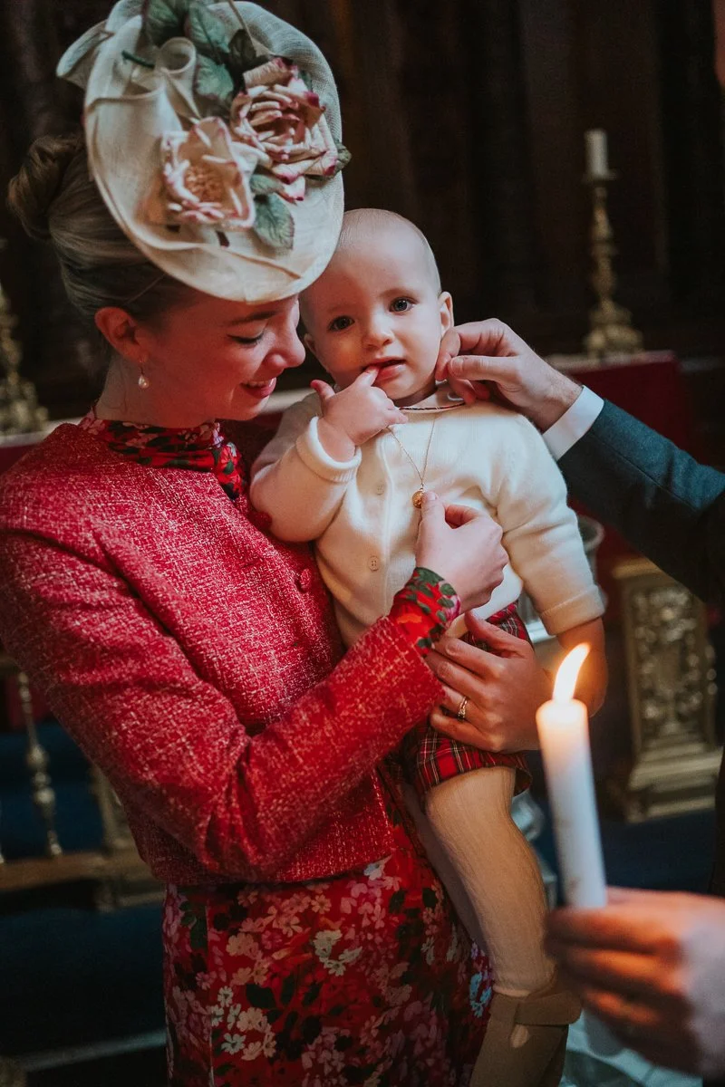  Mother holding her baby during a christening in the Chapel of the Order of St Michael and St George inside St Paul’s Cathedral, photographed in low natural light without flash 