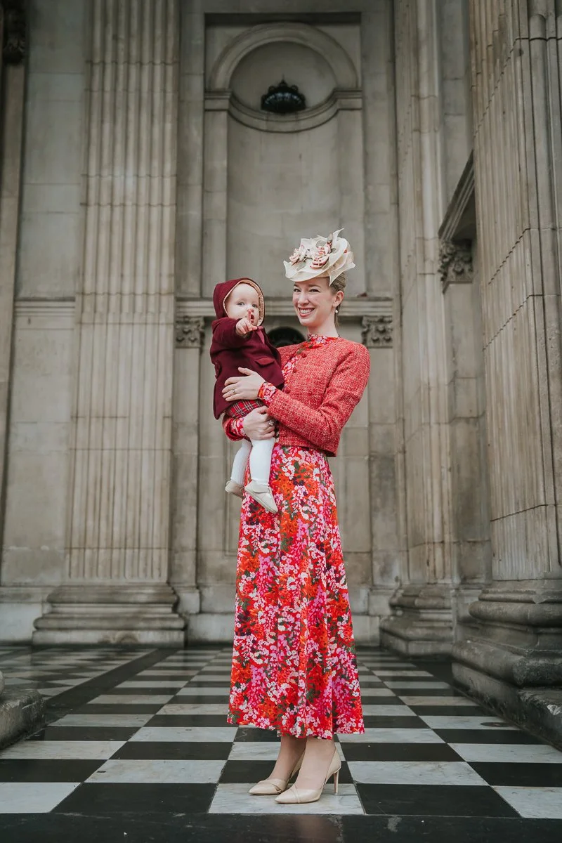  Mother holding her baby on the steps of St Paul’s Cathedral after a christening in London 
