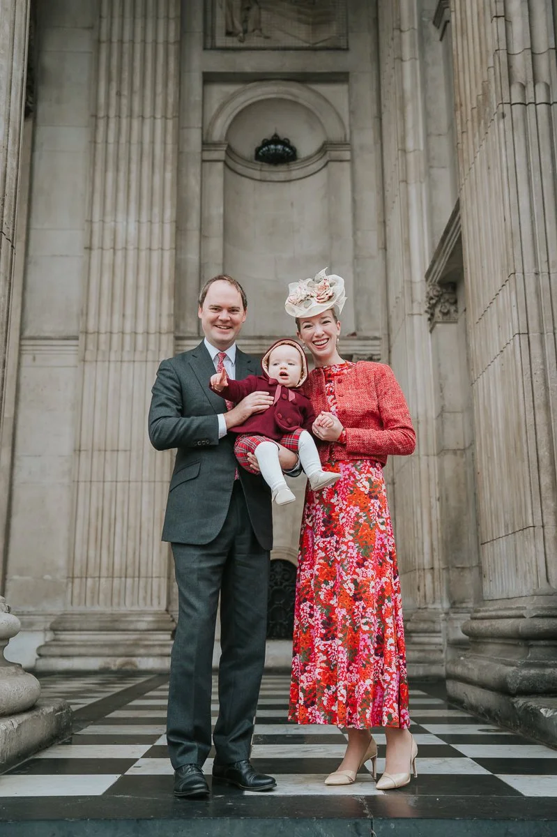  Parents holding their baby on the steps of St Paul’s Cathedral after a London christening 