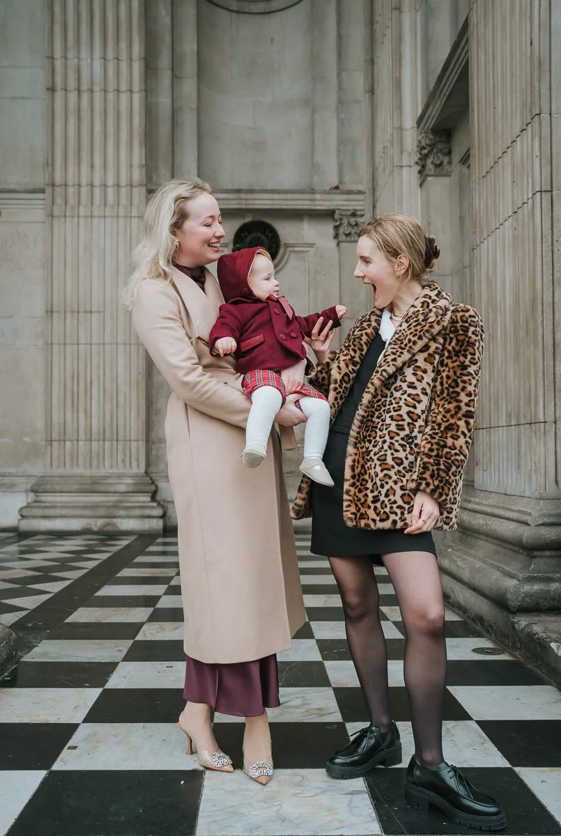  Family moment outside St Paul’s Cathedral with baby and godparents on the cathedral steps 