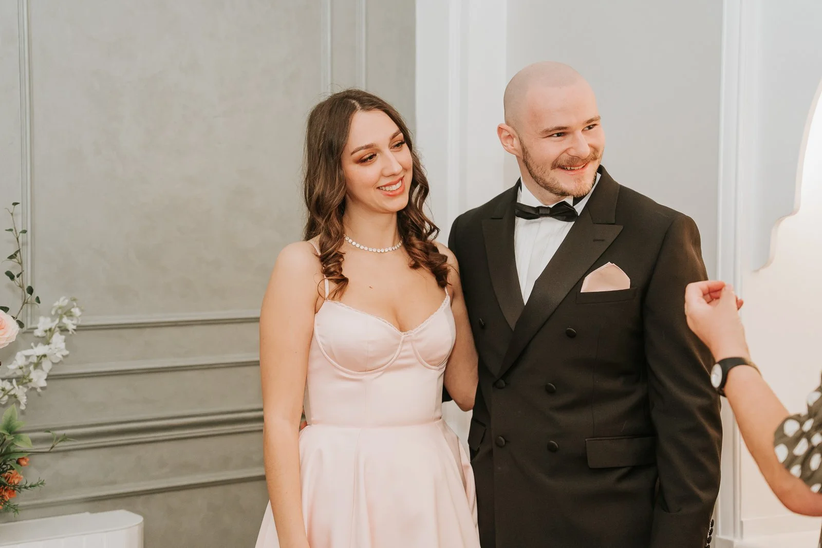  Newly married couple smiling together during their Chelsea Old Town Hall civil ceremony moments after exchanging vows. 