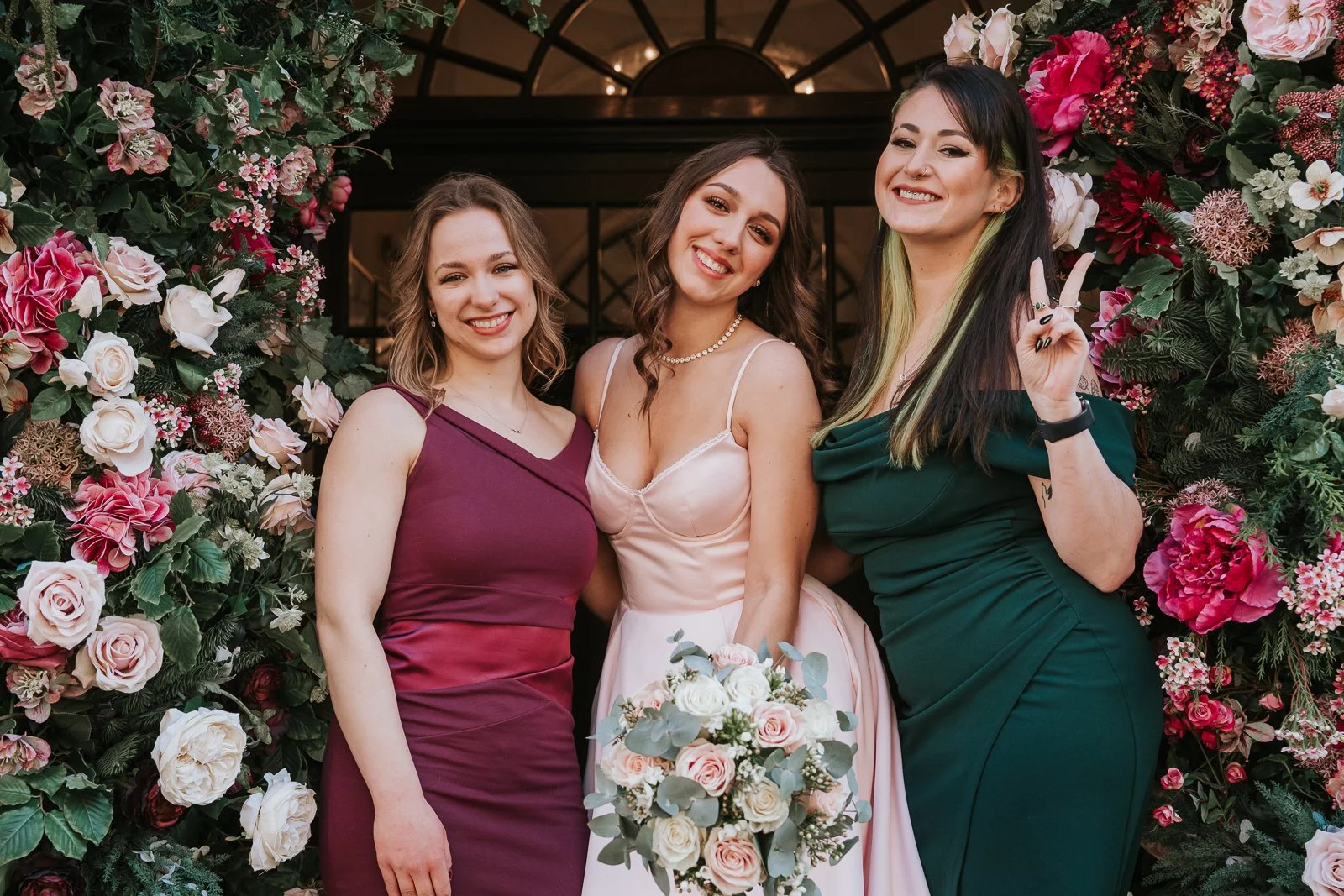  Bride and bridesmaids posing together outside after a small London wedding ceremony. 