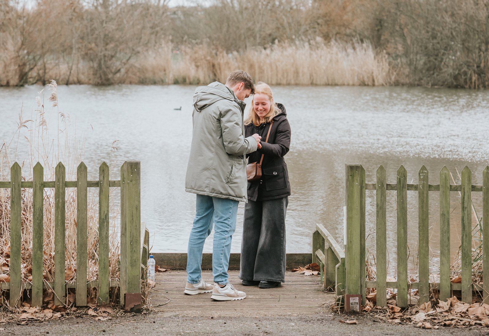 Engagement ring moment at Clapham Common lake as newly engaged couple celebrate their London proposal. 